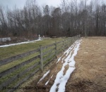 melting snow by board fence